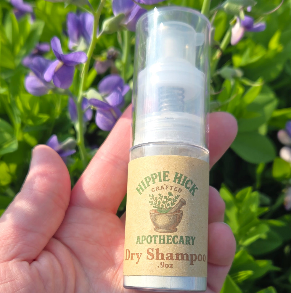 Powder Dry Shampoo in puffer bottle with purple flowers background