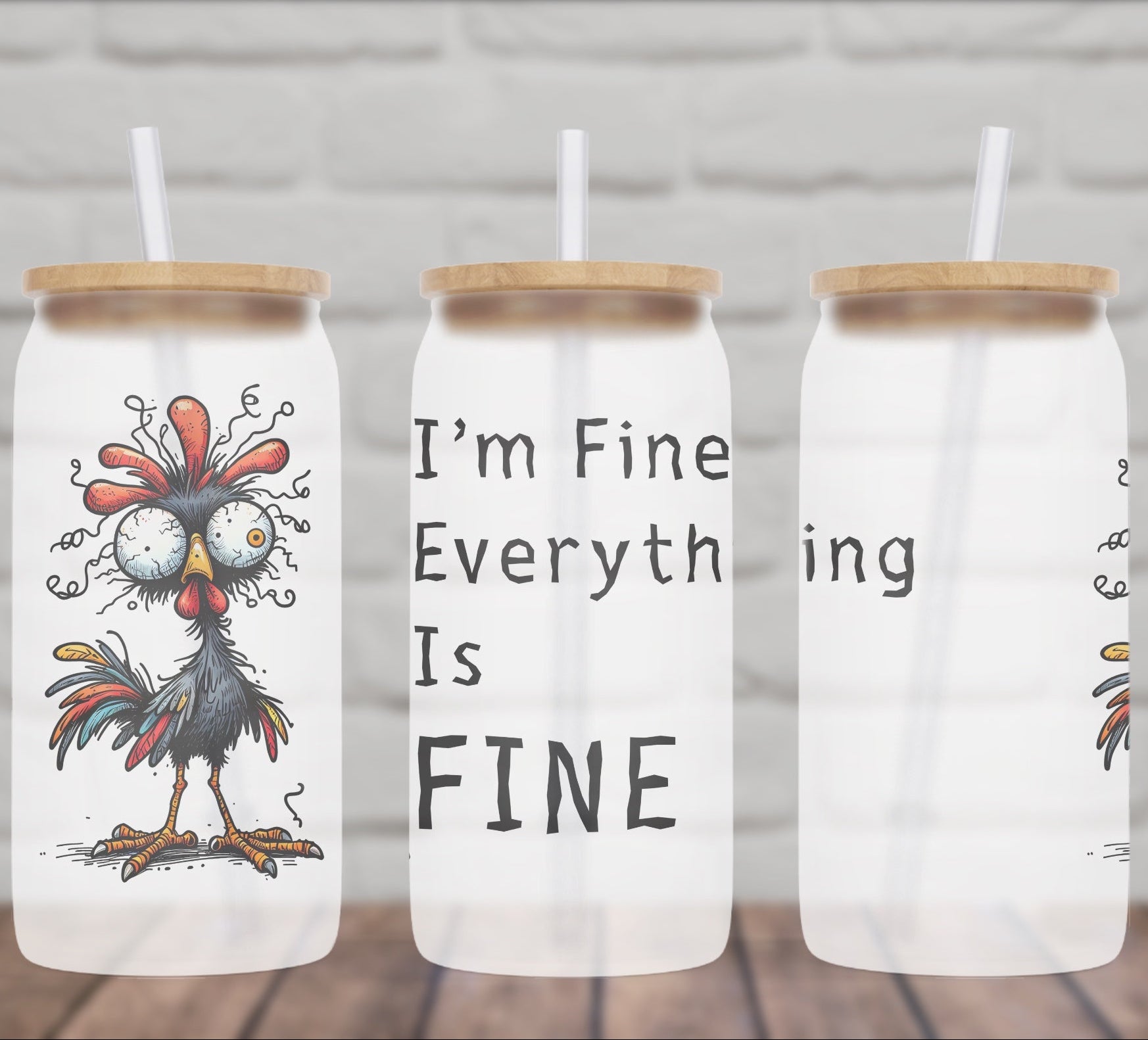 Three glass jars with rooster designs and text on a wooden surface.