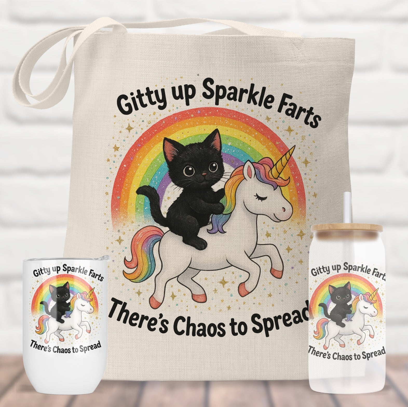 Tote bag with black cat on unicorn design, surrounded by matching mug and bottle on a wooden surface.