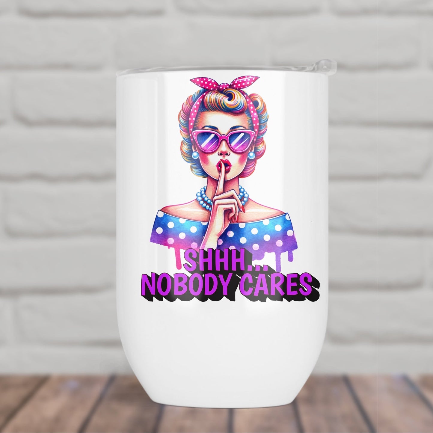 White tumbler with a colorful design of a girl with pink hair and sunglasses, and text 'ISHHH.