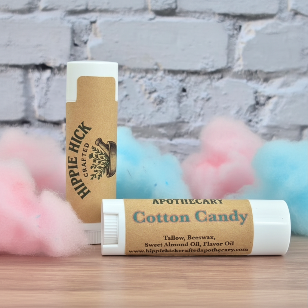 Two lip balm sticks with on a wooden surface and stone wall background.